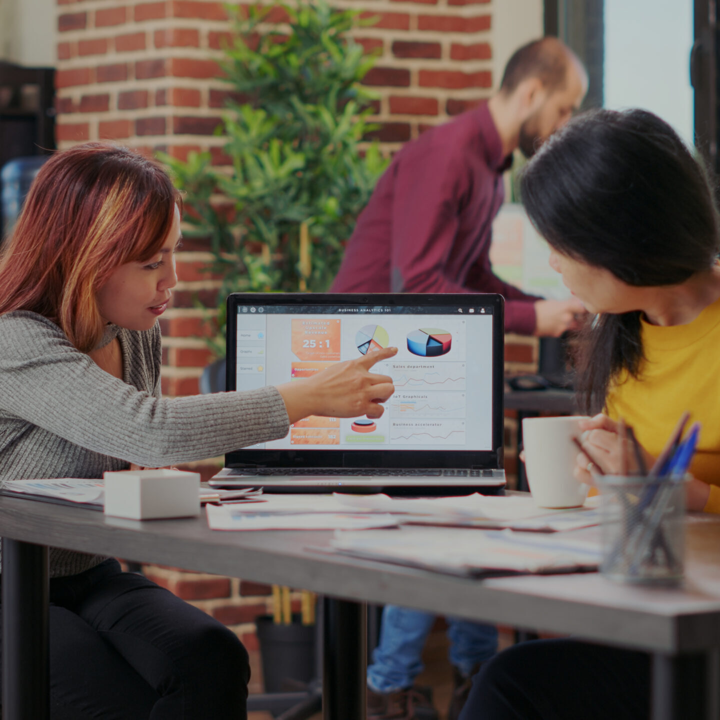 Business people examining statistics on laptop to do research for financial growth. Team of women working on marketing productivity for organization development and successful project.