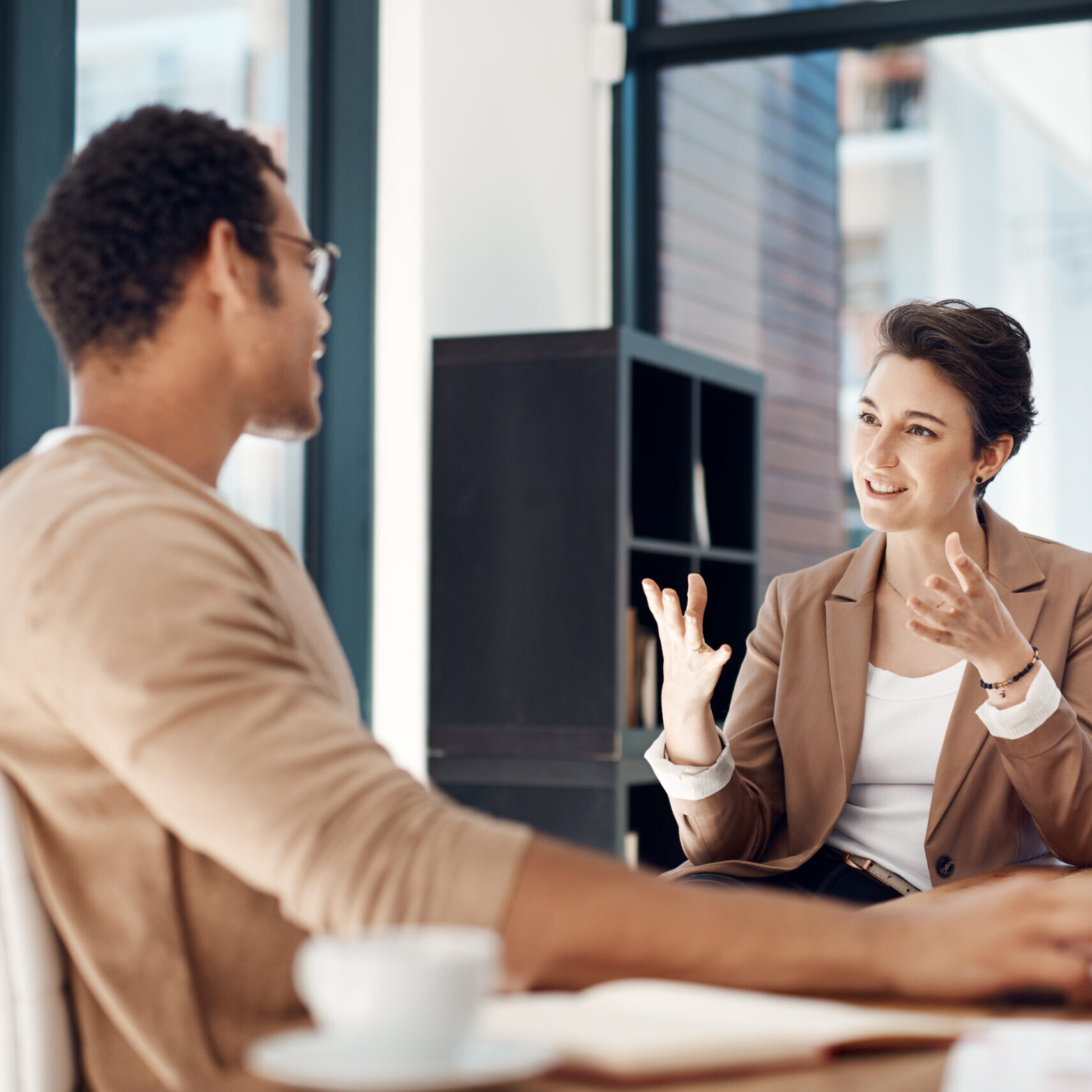 Mentor, training and a woman manager with an employee in the office for coaching on company vision. Management, meeting and a female business person talking to a professional male colleague at work.